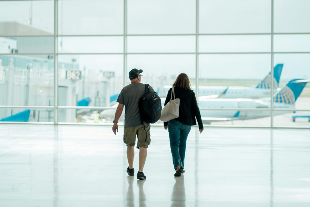 a man and a woman walking through an airport